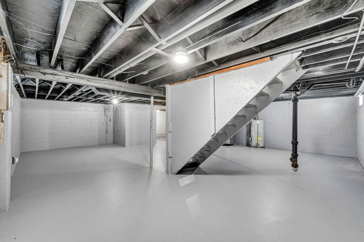 Open basement with a clean gray coated floor