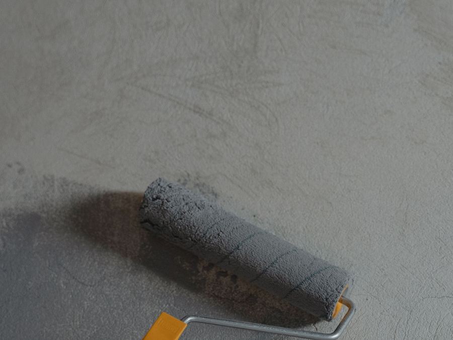 Paint roller on a gray concrete floor